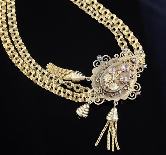A Victorian style gold necklace, with pierced and gem set slide with scrolling border, overall length 72.5cm.